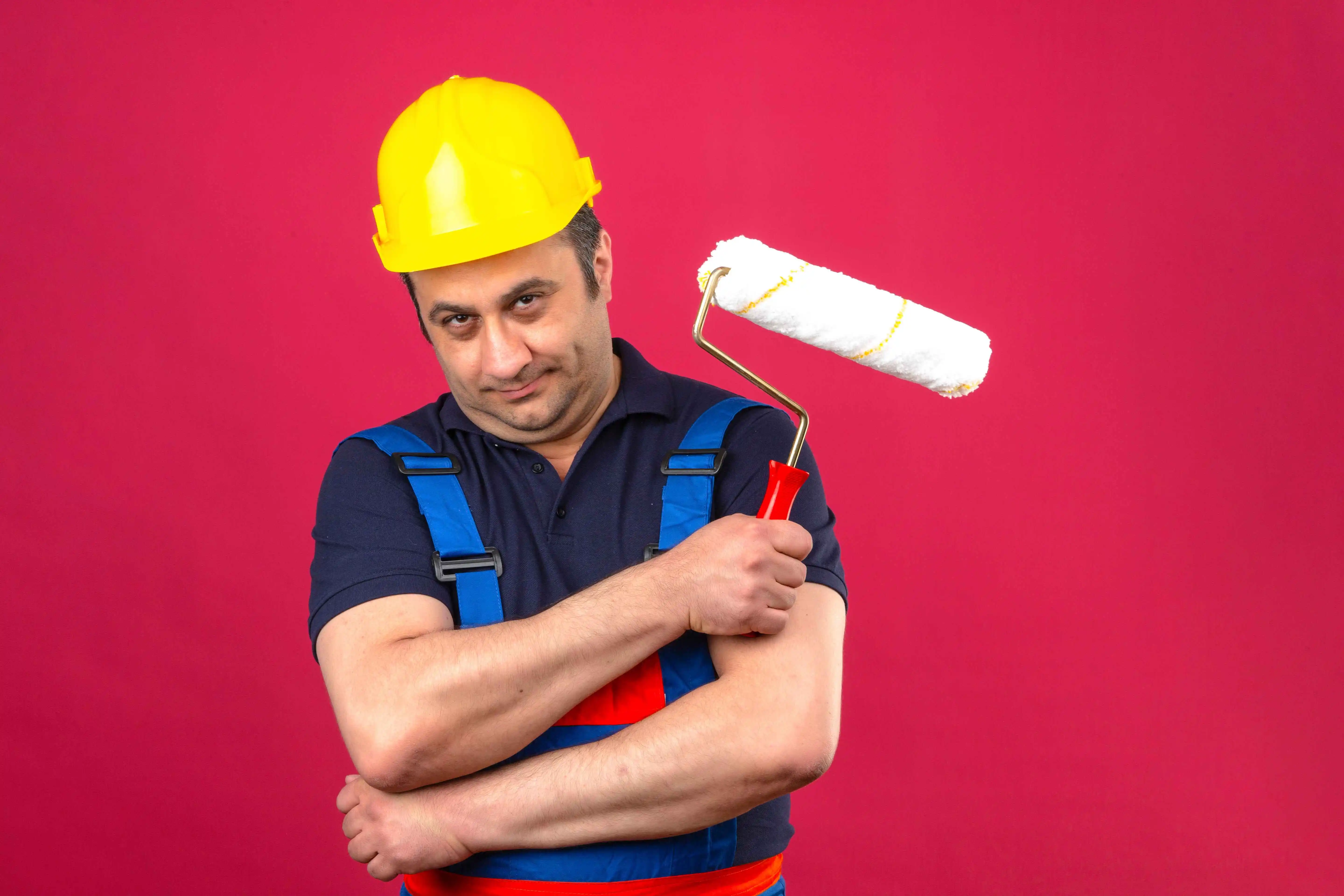 builder man wearing construction uniform safety helmet standing with paint roller feeling skeptic doubtful isolated pink wall 1 1